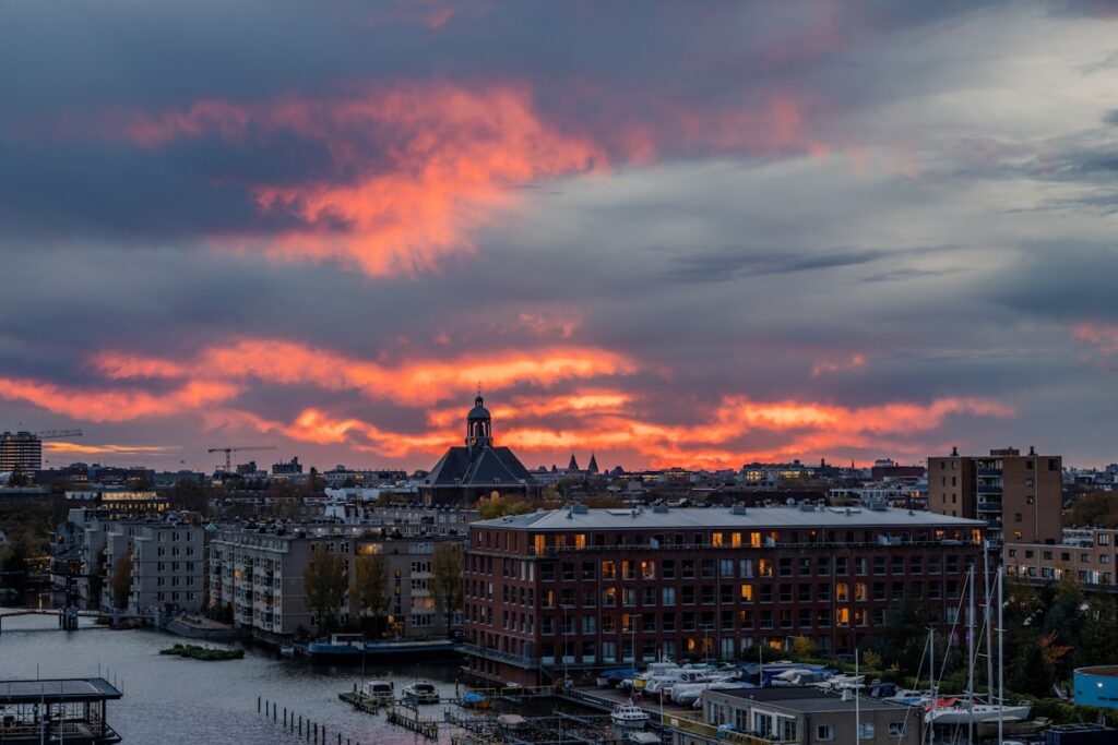 Amsterdam canal with historic buildings at sunset