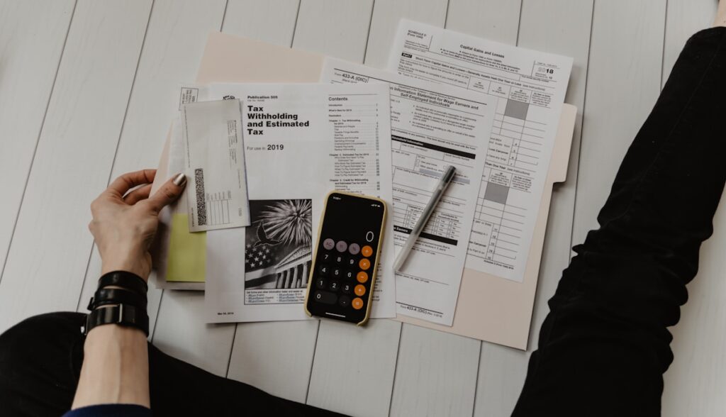 Calculator and tax documents on desk for wealth tax planning in Spain